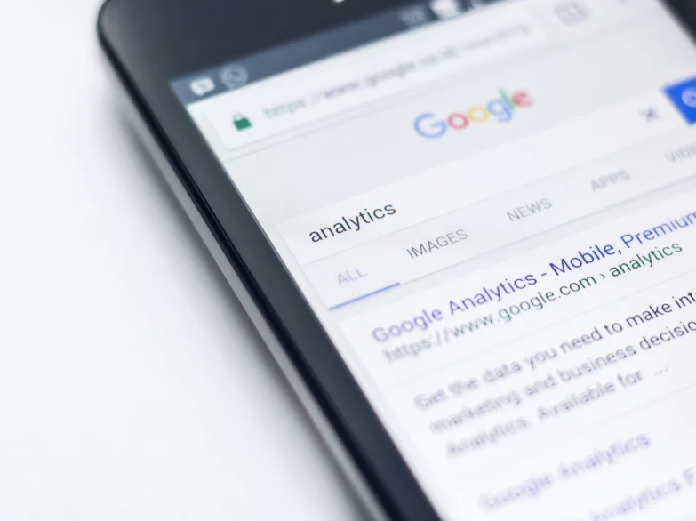 Close up of a mobile phone screen displaying a page link to Google Analytics.